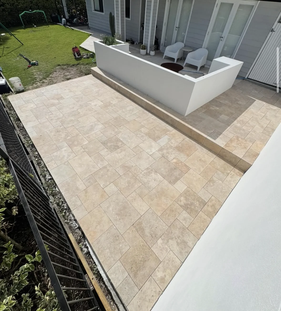 French pattern paving around a stepped white patio in Currumbin